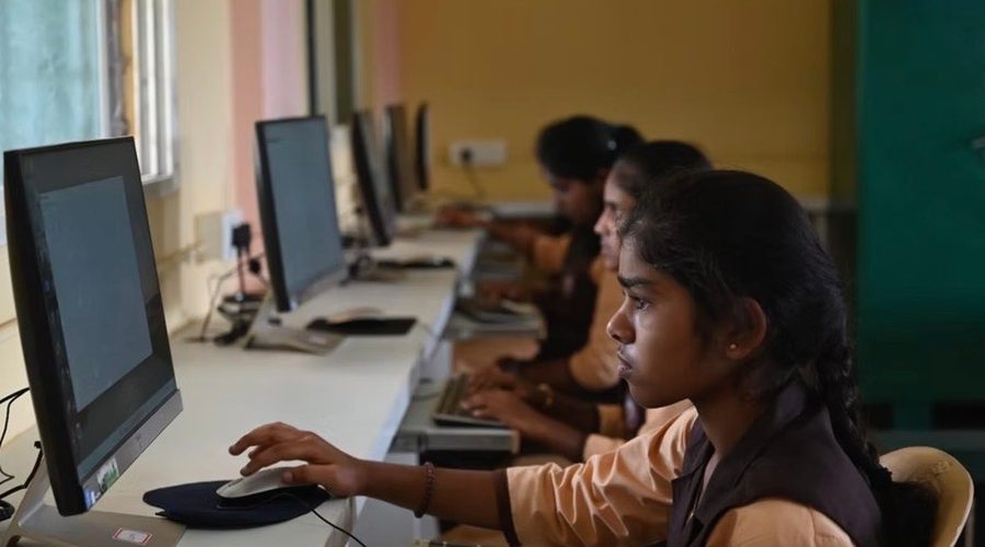 Students working at computers in a training lab